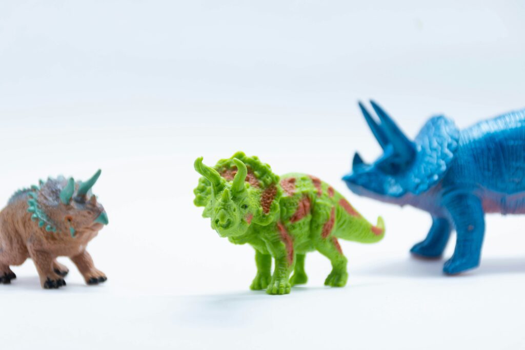 Brightly coloured brown, green and blue Triceratops toys